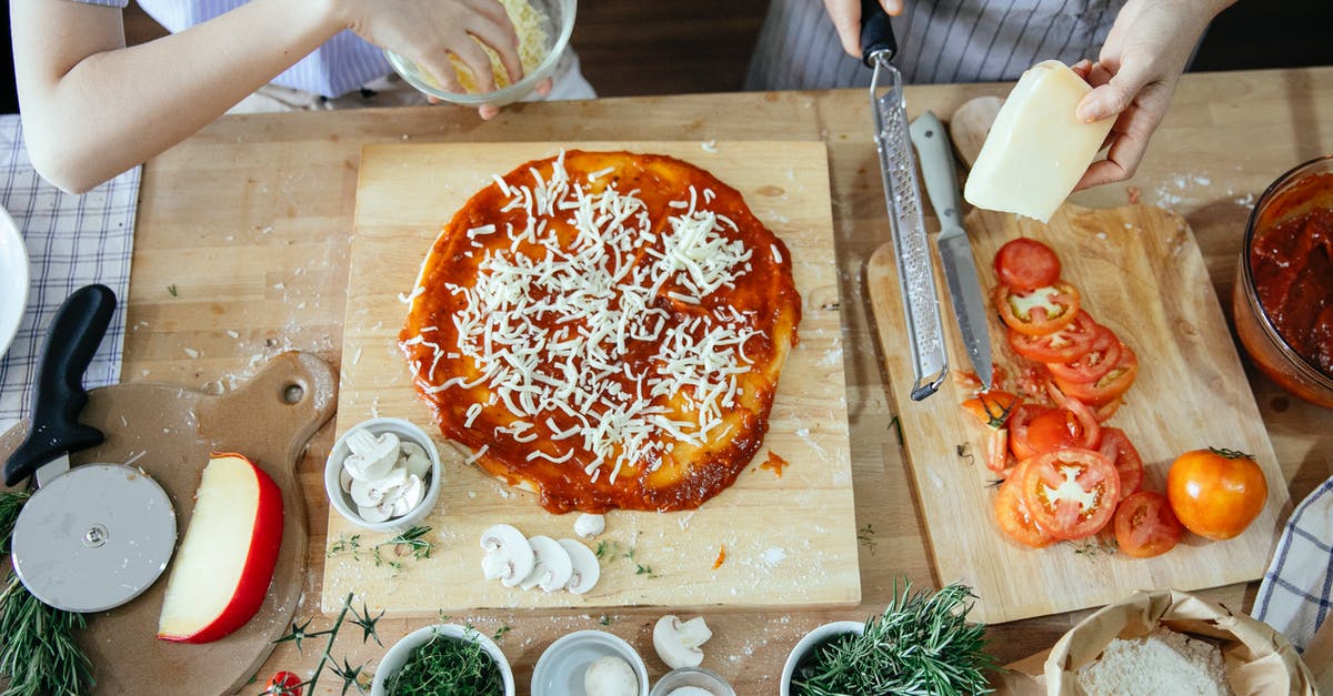 Can I turn my marinara sauce recipe into "pizza sauce"? - Crop women adding cheese on pizza