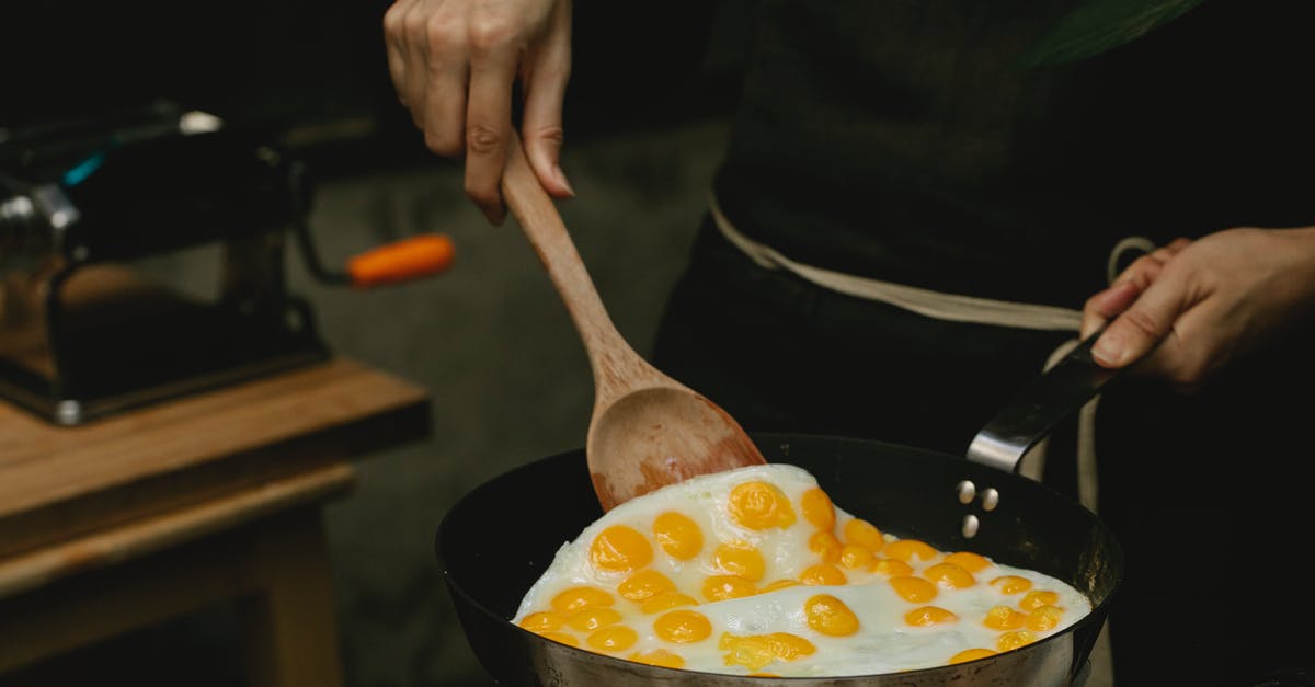 Can I turn off stove while making stock? - Crop faceless chef frying quail eggs in pan