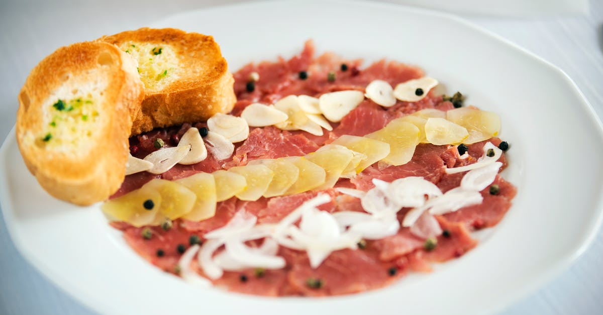 Can I use fermented milk product as starter culture? - Tasty appetizer of carpaccio with raw onion and ginger slices with black peppercorns on plate in restaurant on white background