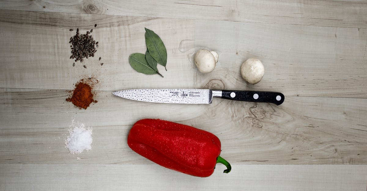 Can I use garlic leaf for cooking? - Kitchen Knife Placed Next to Pepper