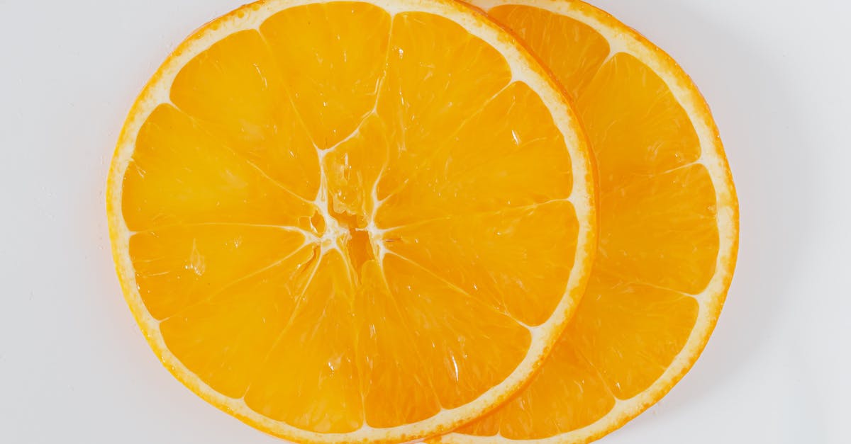 Can I use orange juice to pasteurize egg whites? - Top view closeup of cut round slices of fresh orange on white background