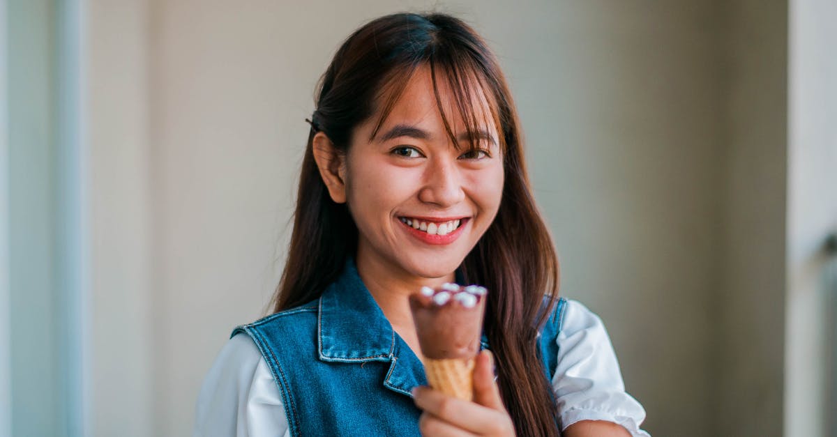 Can Ice Cream Maker Wall be Too Cold? - Smiling Asian woman with chocolate ice cream
