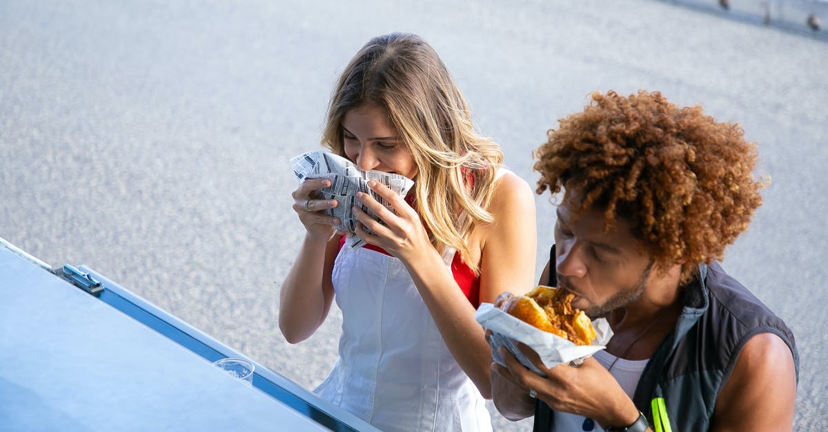 Can meat and cheese be stored together? - High angle of diverse hungry couple having lunch with burgers together at food truck