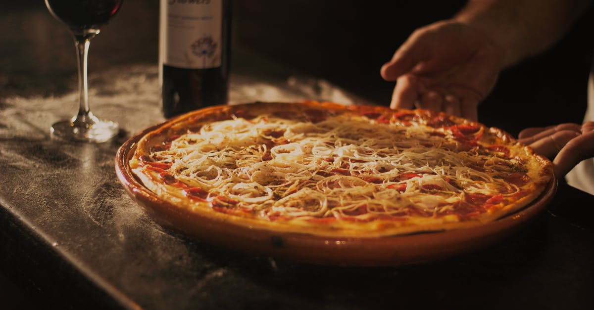 Can meat flavored tomato sauce be used without heating? - Person Holding Pepperoni Pizza on Tray