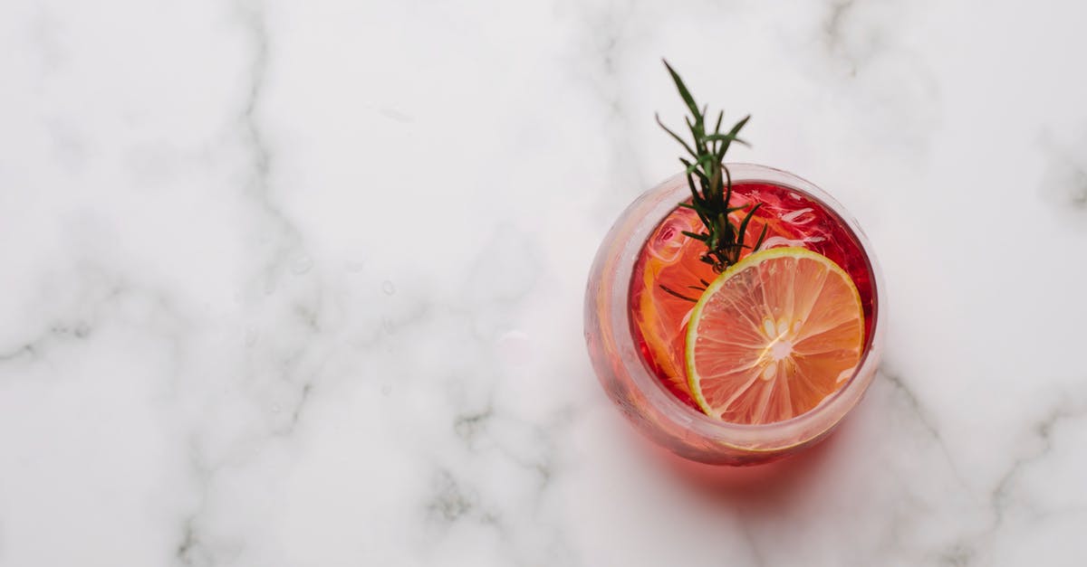 Can meat freeze from the inside out? - Glass with cocktail with lemon and rosemary placed on table