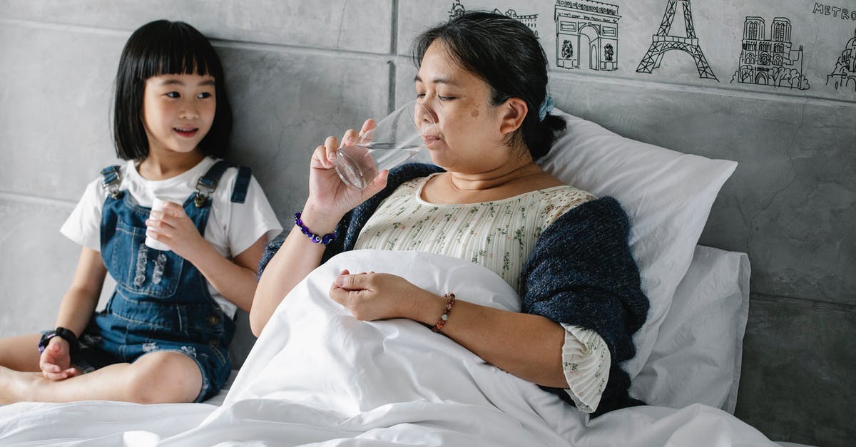Can one get sick from drinking too much home made Water Kefir? [closed] - Adorable ethnic child giving pills to unhealthy grandmother drinking water in bed