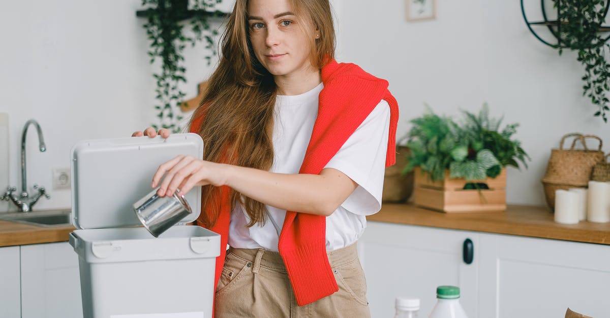 Can panettone paper molds be used for other things? - Responsible female sorting garbage while putting tin can into container for metal litter and looking at camera