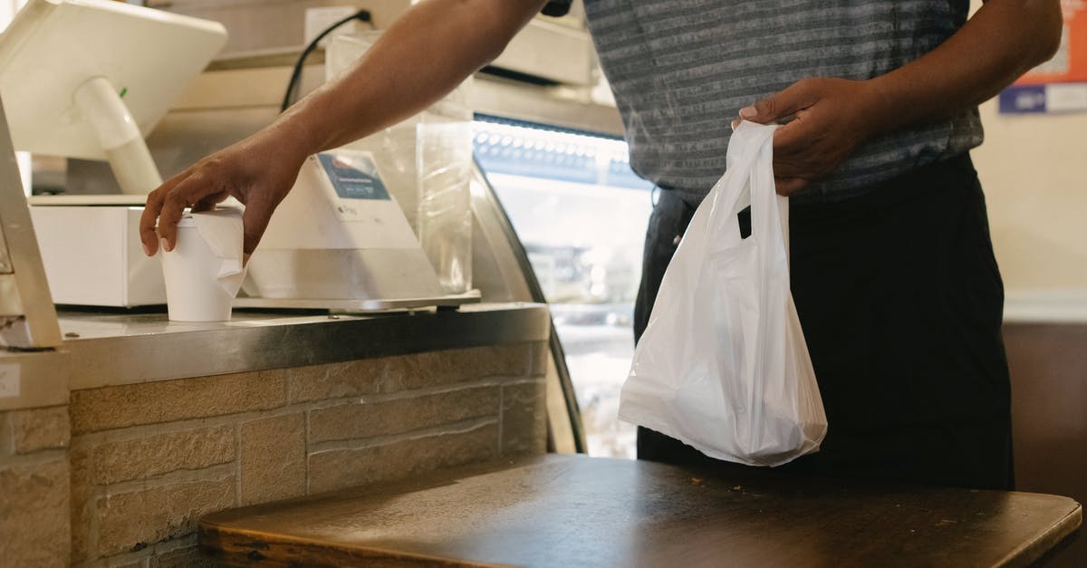 Can plastic grocery store misters be used for oil? - Crop man with purchases in store