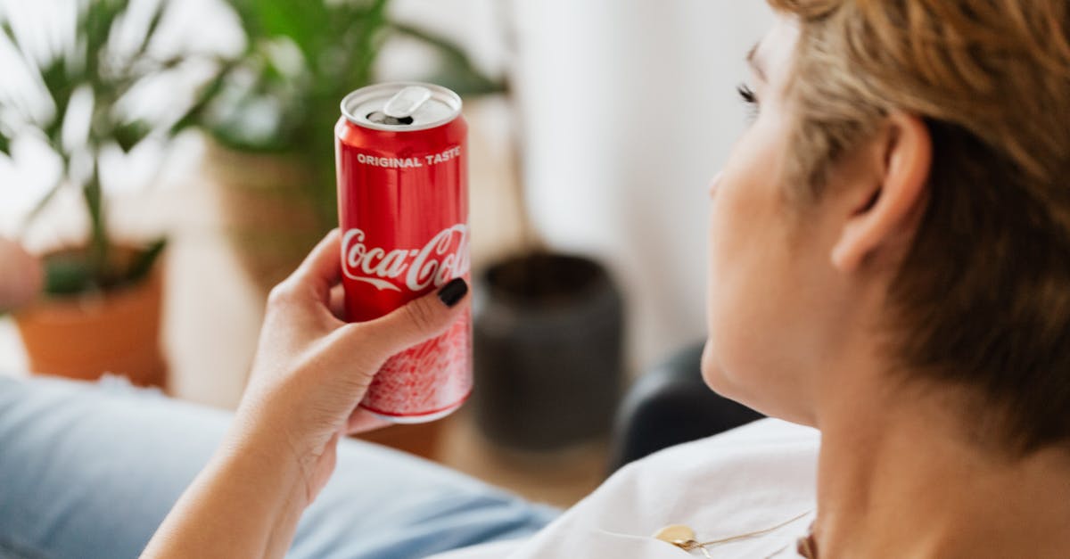 Can red lentils be used for mujadara? - Crop anonymous woman resting at home with can of coke