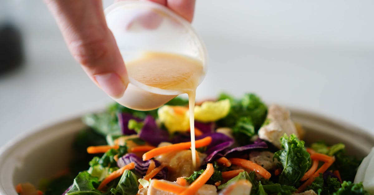 Can salad dressing be made with coconut oil? - Close-Up Photo of a Person Pouring Salad Dressing into Vegetables