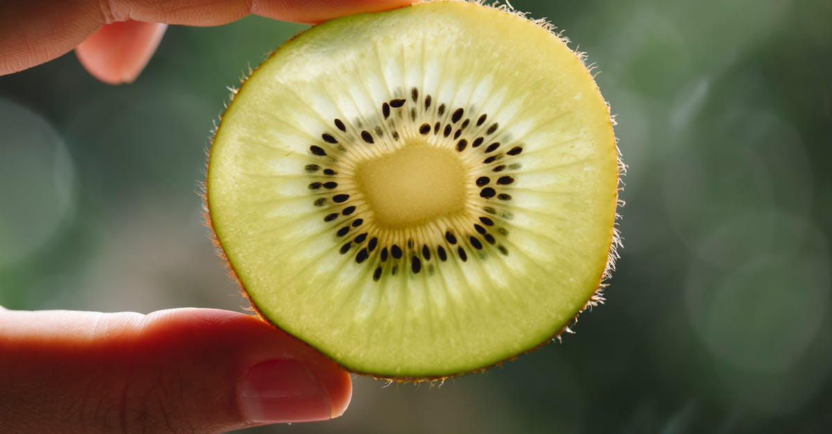 Can salmonella show up in a raw-egg product once it has already been made? - Crop anonymous person demonstrating pulp texture of ripe kiwi with seeds at sunshine