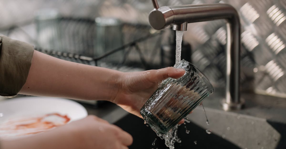 Can some dishes be washed with only water? - Person Pouring Water on Clear Drinking Glass