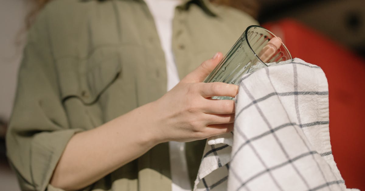 Can some dishes be washed with only water? - Person in Gray Button Up Shirt Holding Clear Drinking Glass