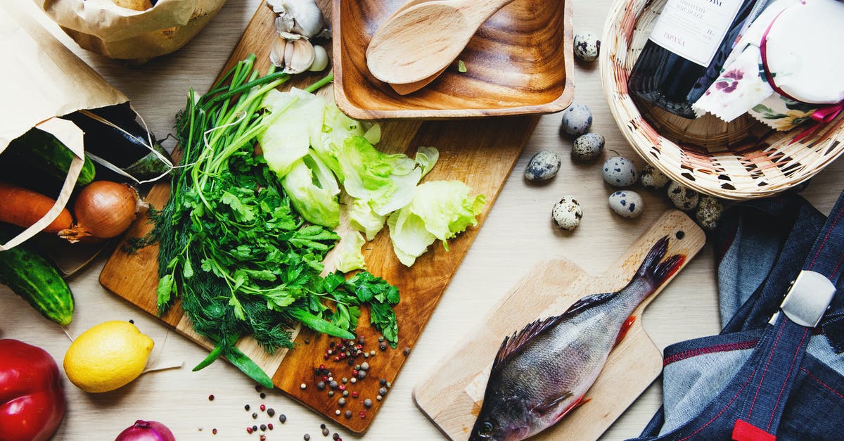 Can someone please give an explanation of different egg preparations? - Fresh vegetables and fish on cutting board in kitchen