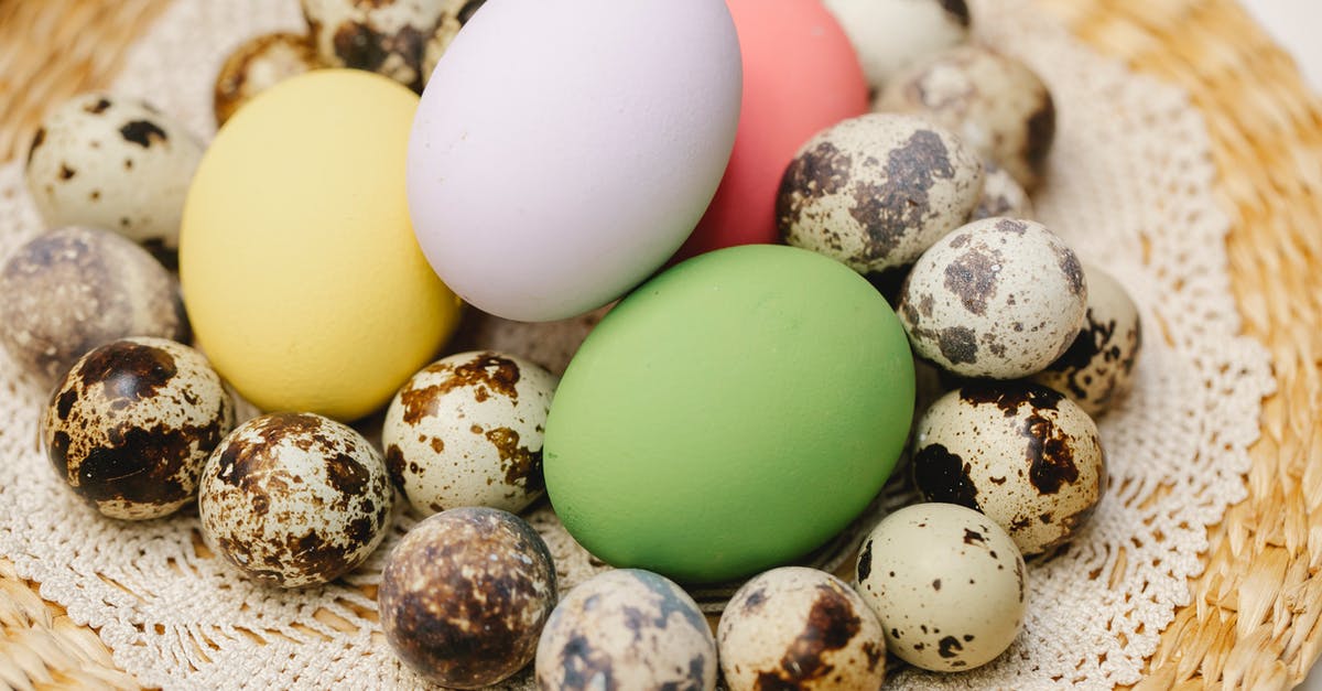 Can someone please give an explanation of different egg preparations? - From above of multicolored eggs and heap small spotted quail eggs placed on lace doily during Easter holiday in kitchen