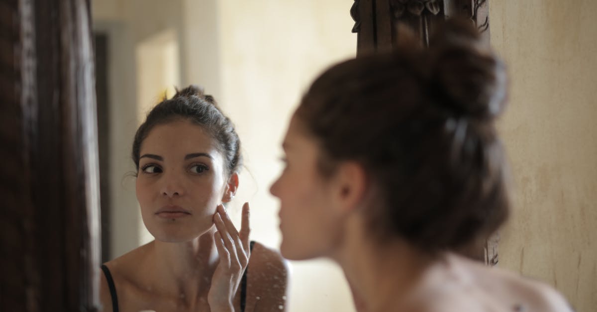 Can the skin of lychee be used for anything? - Reflection Photo of Woman Touching Her Cheek