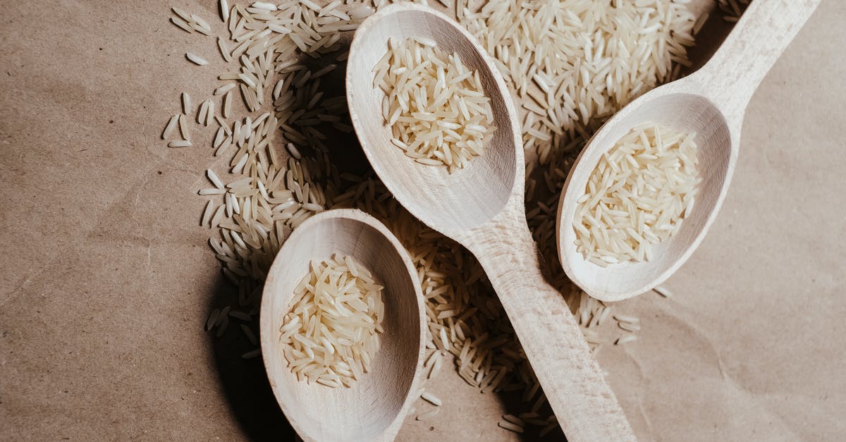 Can uncooked rice be stored in the freezer or refrigerator? - A White Rice on a Wooden Spoons