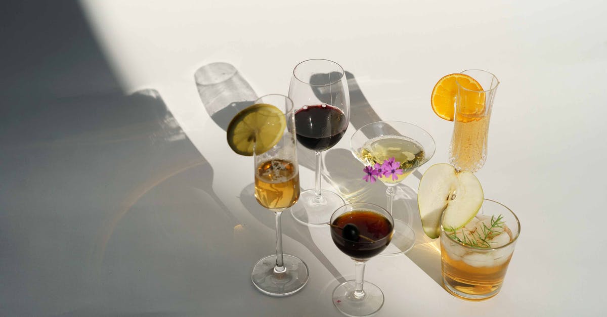 Can wine be made from citrus fruits? - High angle of assorted alcohol drinks including red wine with champagne Manhattan and Martini cocktail near glass of pear brandy