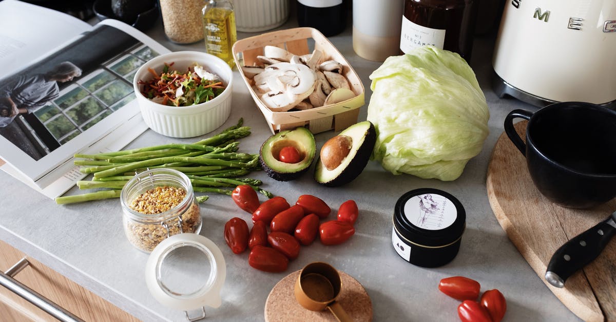 Can wine be made from tomatoes? - From above of various organic vegetables chopped ingredients near cutting board kitchenware appliances and trendy magazine placed on gray countertop in kitchen at home