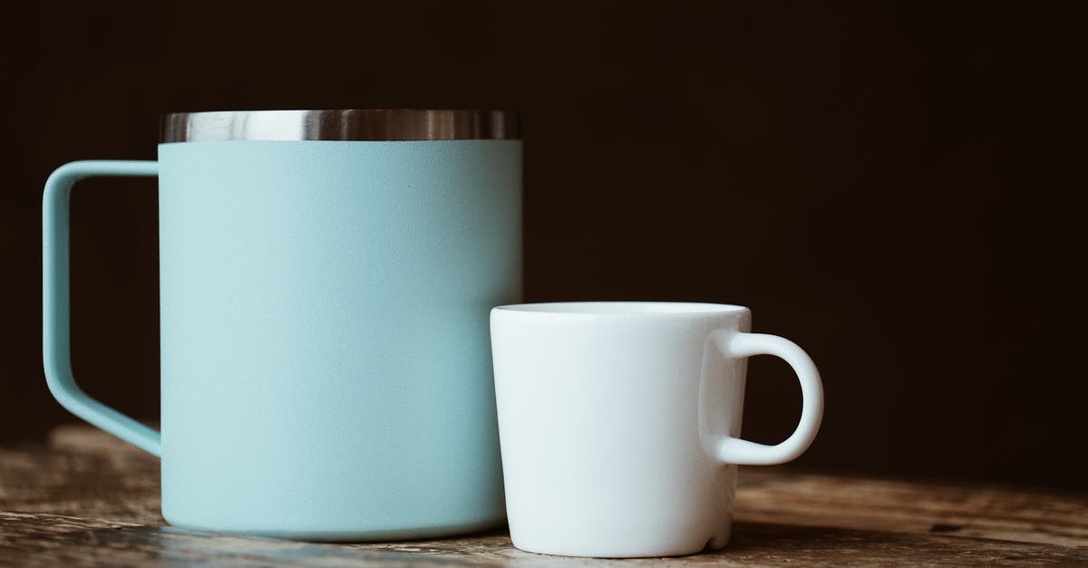 Can you brew black tea in a macchinetta? - Blue and white mugs placed on shabby table