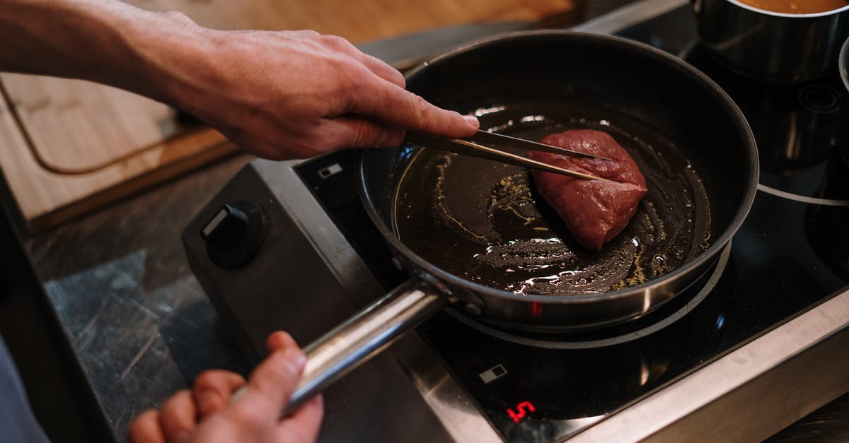 Can you butter-baste steak without a gas stove? - Person Cooking on Black Pan