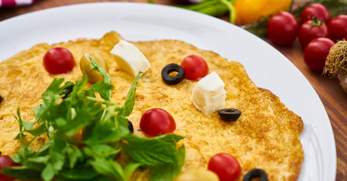 Can you eat red tomatoes' seeds that turned black? - Selective Focus Photography of Omelette With Toppings