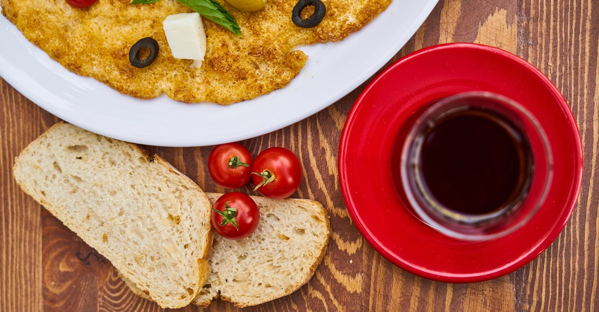 Can you eat red tomatoes' seeds that turned black? - Flat Lay Photo of Bread on Brown Surface