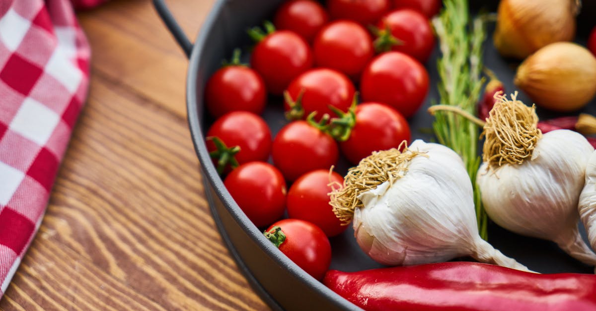 Can you eat red tomatoes' seeds that turned black? - Red Tomatoes and Garlics in Cooking Pot