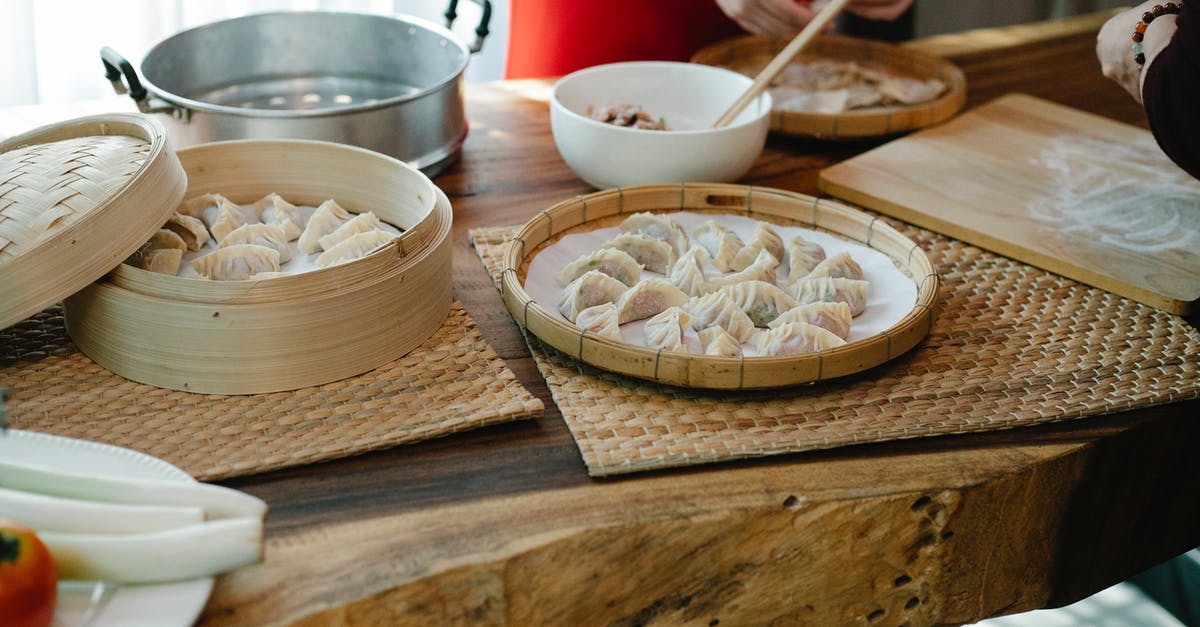 Can you fold dough during autolyse? - Crop unrecognizable ladies folding traditional Chinese dumplings in kitchen