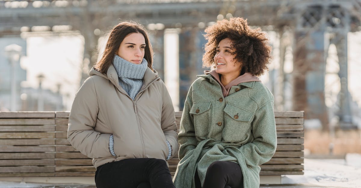 Can you freeze Spring Roll Wraps? - Positive diverse women in outerwear sitting on bench on embankment