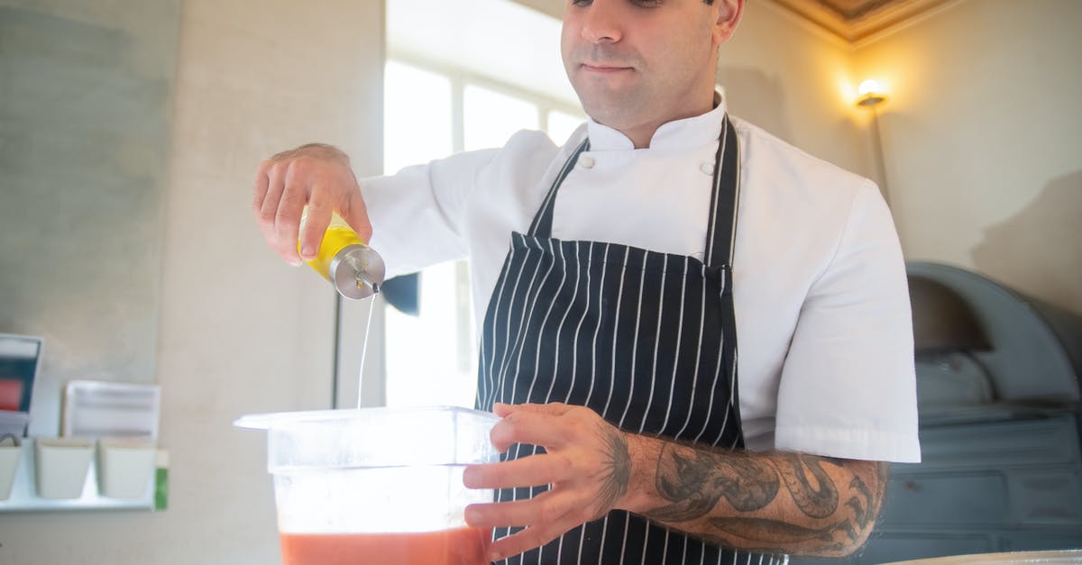 Can you interchange oil and butter in emulsified sauces? - Man in Striped Apron Pouring Oil into Bowl