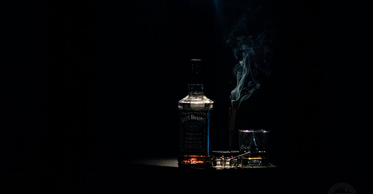 Can you put a bottle of whiskey in the oven - Closeup Photo of Liquor Bottle Against Black Background