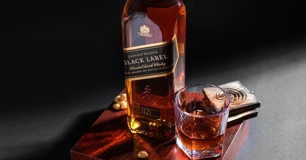 Can you put a bottle of whiskey in the oven - A Bottle of Black Label on a Wooden Board