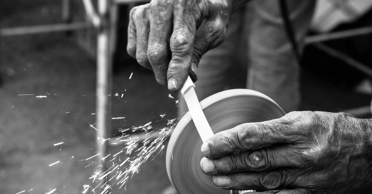 Can you use regular knife sharpeners on damascus steel? - Crop craftsman grinding knife in workshop