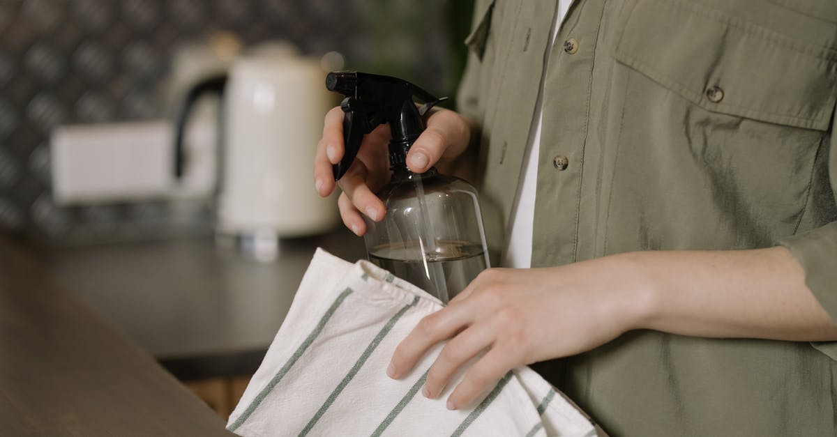 Can You Wash a Wok? - Person in Green Button Up Shirt Holding Clear Drinking Glass