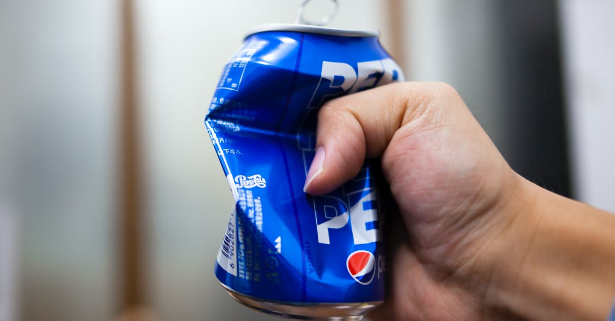 Canned cubed tomatoes vs crushed - A Person Crushing a Can of Soda