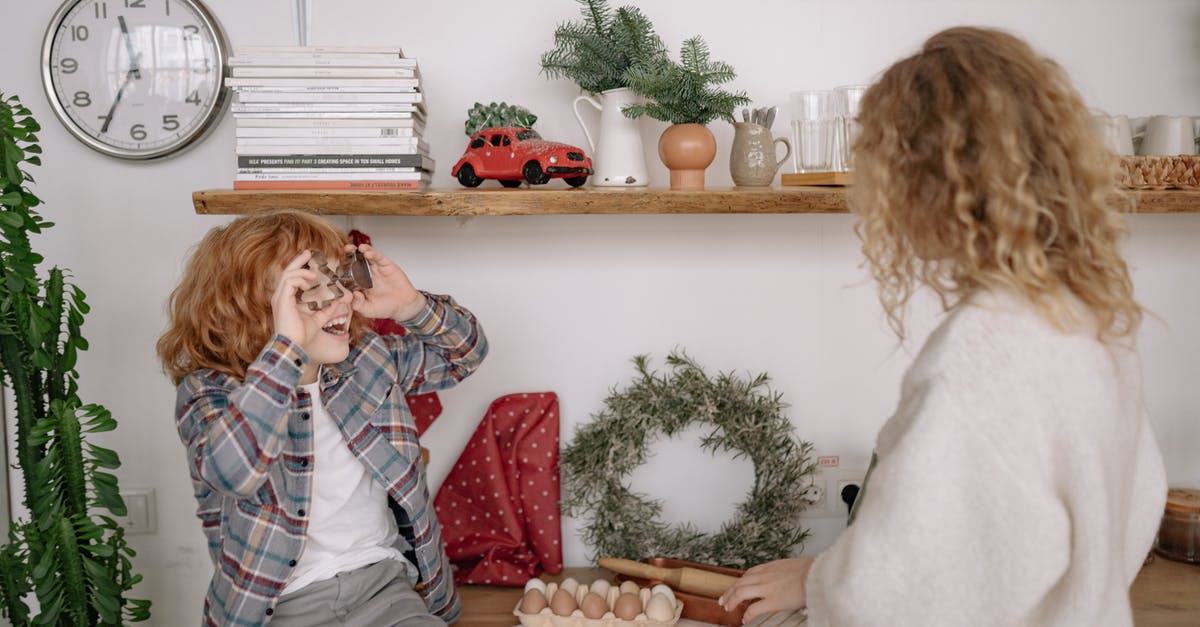 Canned (shelf stable) pickled eggs that don't require refrigeration? - A Boy in Plaid Shirt Sitting on a Wooden Table Facing a Woman With Curly Hair