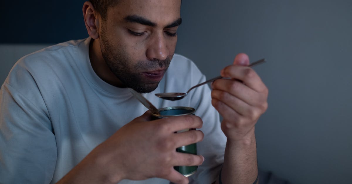 Canned (shelf stable) pickled eggs that don't require refrigeration? - Man Wearing White Shirt Eating Canned Food