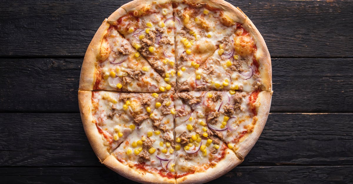 Canned yams vs. fresh - Tasty pizza with canned corn grains on wooden surface