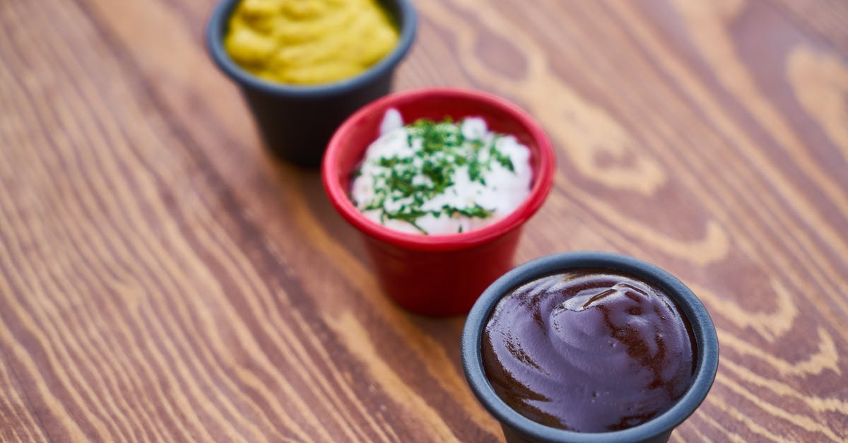 canning a mustard vinegar sauce - Three Assorted-color of Cream in Containers on Brown Wooden Slab