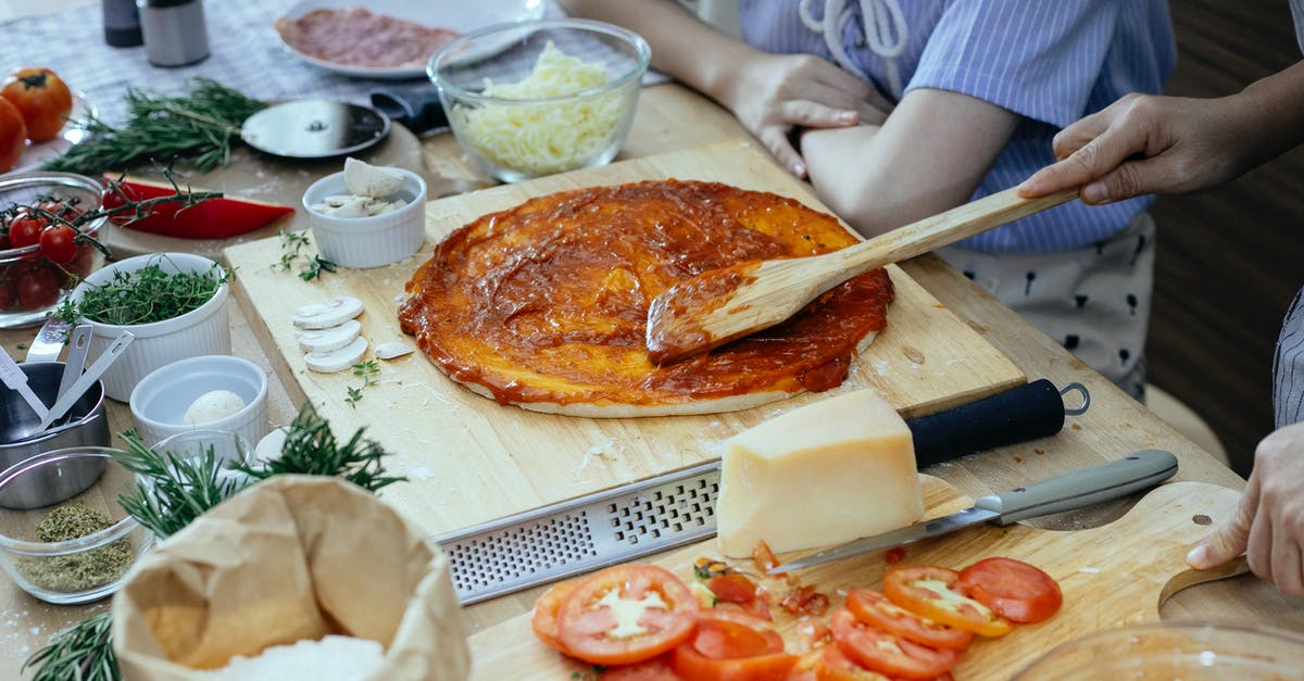 Canning sauce time - Women in process of preparing homemade pizza