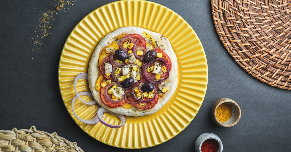 Canning tomato sauce problem, jar broken in boiling method - Flat lay of pizza made of thick dough with vegetables and cheese served in plate near jars with condiment and wicker dishes