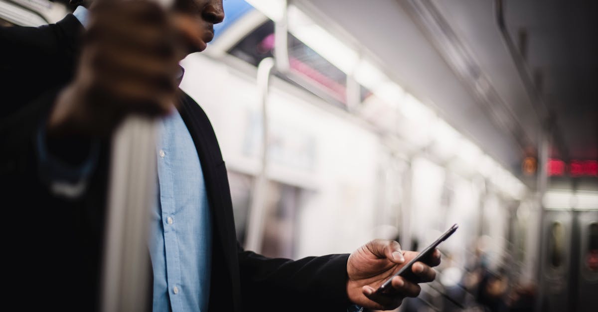 Can/should I use rapid rise yeast for longer proofing? - Black man using mobile while commuting by train