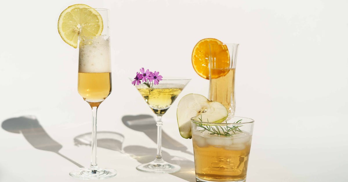 Caramel Apple cocktail garnish - Clear Drinking Glass With Yellow Liquid