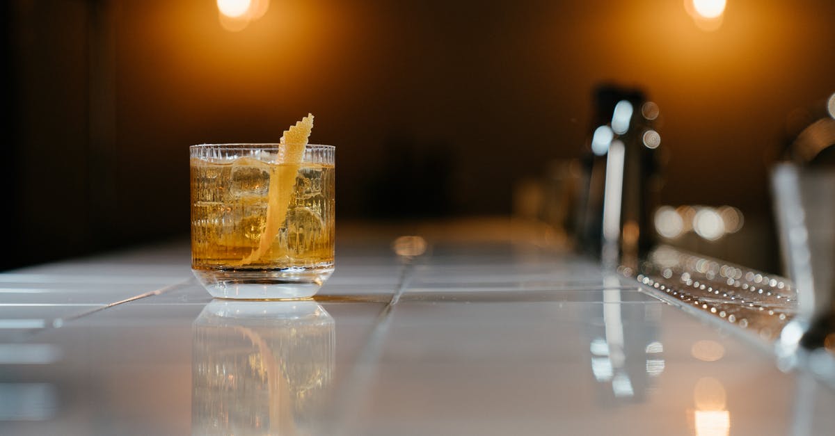 Caramel Apple cocktail garnish - Clear Drinking Glass With Yellow Liquid on Table