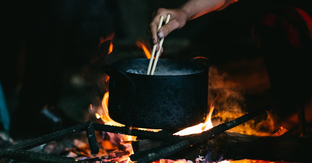 Caramel without stirring or burning - Person Holding Black Pot With Fire