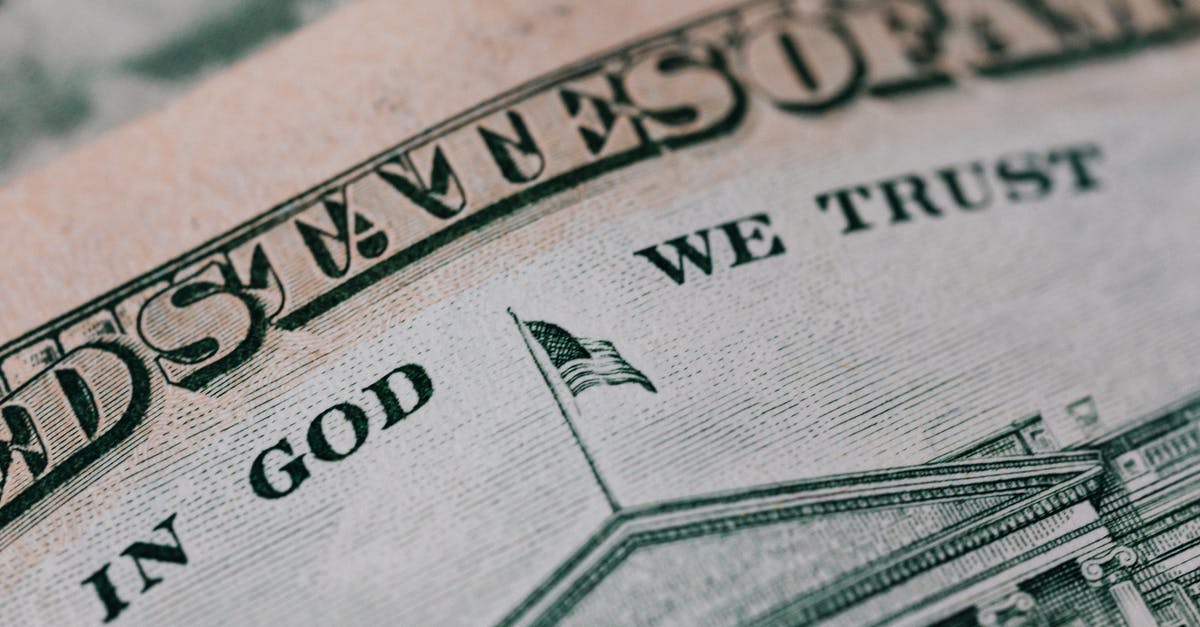 carbon steel pans in dollar store - Closeup of ten dollar with inscription In God We Trust bill placed on table with different money