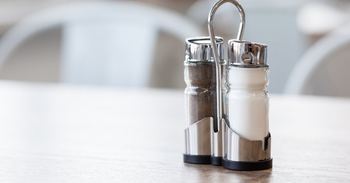 Carbon steel seasoning - Salt and pepper shakers in holder on table