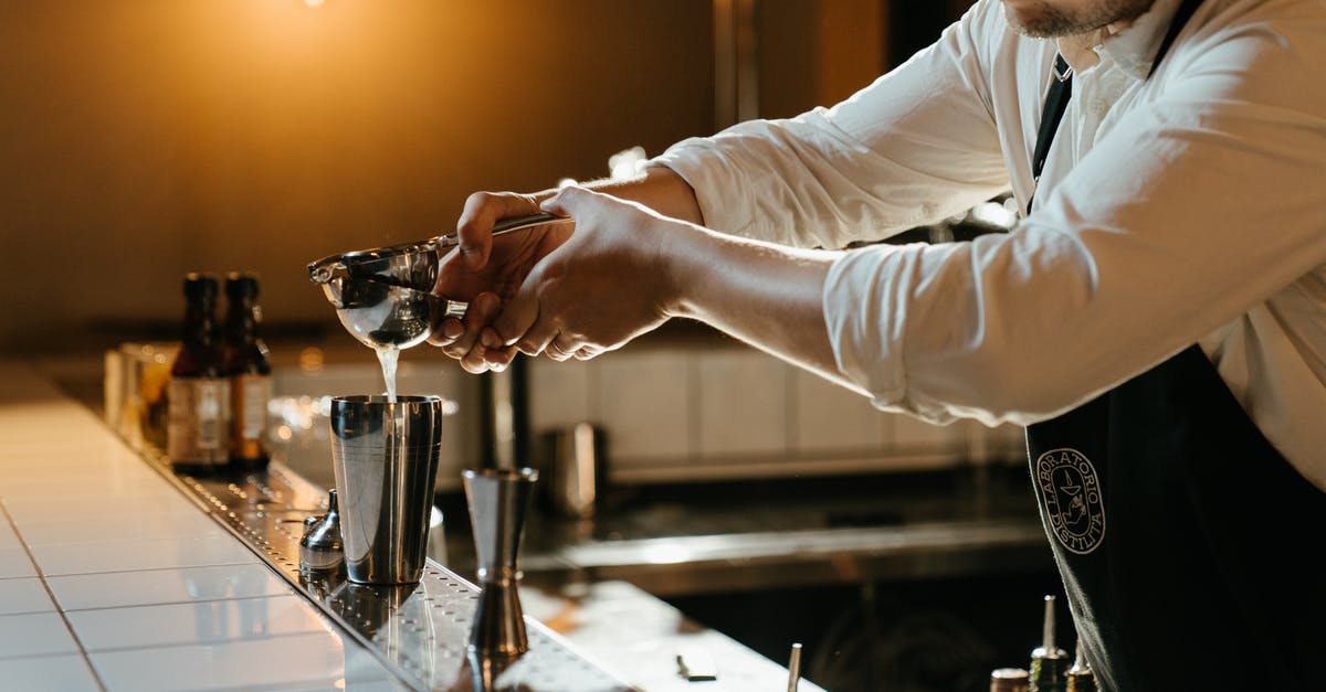 Carbonated drinks in cocktail shakers? - Man in White Long Sleeve Shirt Holding Clear Glass Cup