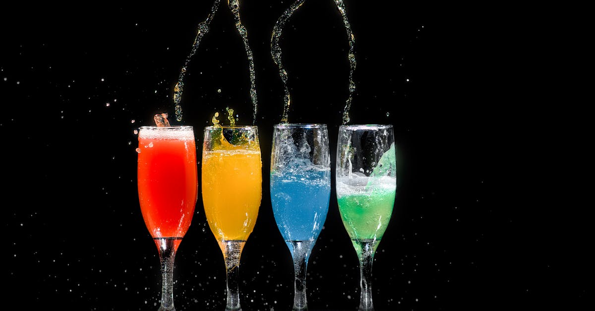 Carbonated drinks in cocktail shakers? - Four Champagne Flutes With Assorted-color Liquids